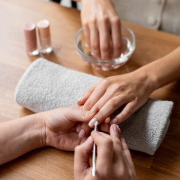 close-up-manicurist-holding-nail-tool.jpg